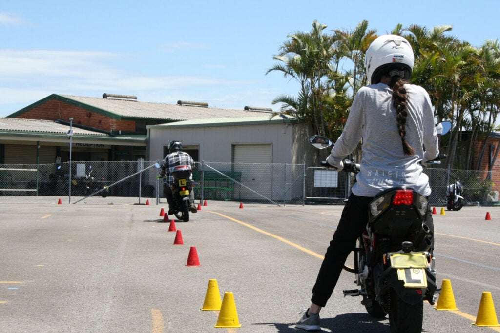 motorcycle driving lesson within traffic cones